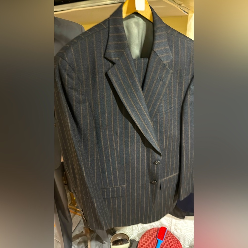 This is a charcoal gray pent strip oran suit 100% wool